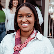 A student smiling. Links to Gifts of Cash, Checks, and Credit Cards