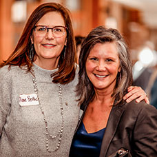 Two women smiling. Links to Gifts of Appreciated Securities
